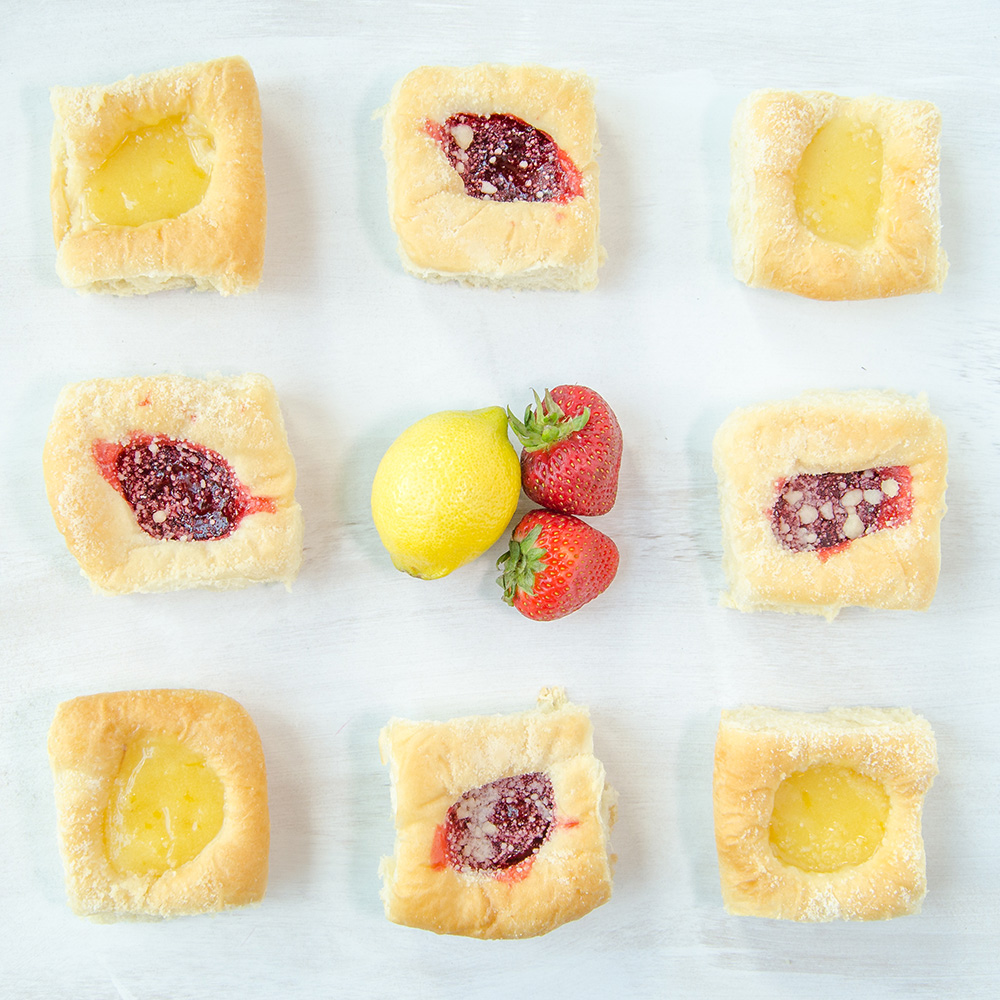 An assortment of Kolache Shoppe's lemon and strawberry kolaches