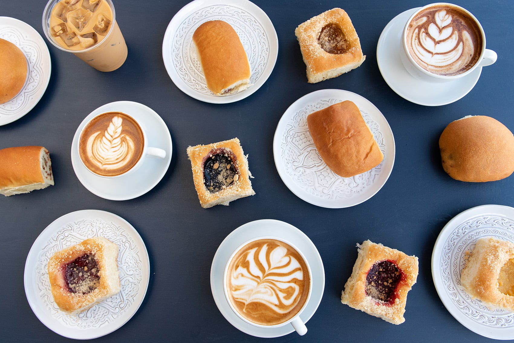 An assortment of sweet and savory kolaches with coffee